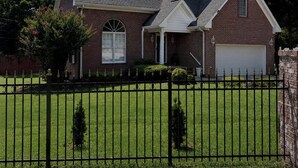 A two-story house with a brick facade, a front garage, and a well-maintained lawn. - Serene 4-bedroom house near Elon (Burlington)