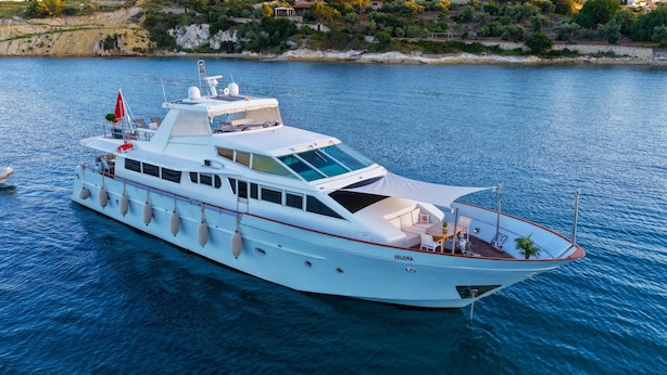 A white yacht with a covered deck, multiple windows, and a flag. - 7 cabins 27M Benetti luxury yacht Velora (İzmir)