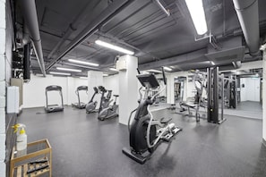 A gym with various exercise equipment, including treadmills and stationary bikes.
