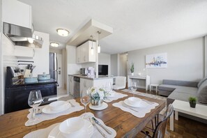 A modern kitchen with a dining area set for six.