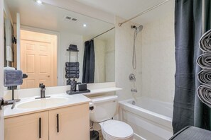 A bathroom with a toilet, sink, and bathtub. - Downtown 1BR Condo w/ WFH Setup & Private Balcony (Toronto)