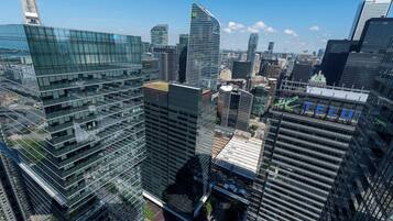 A high-rise urban area with modern glass buildings, including a prominent one with a curved facade and a visible logo.
