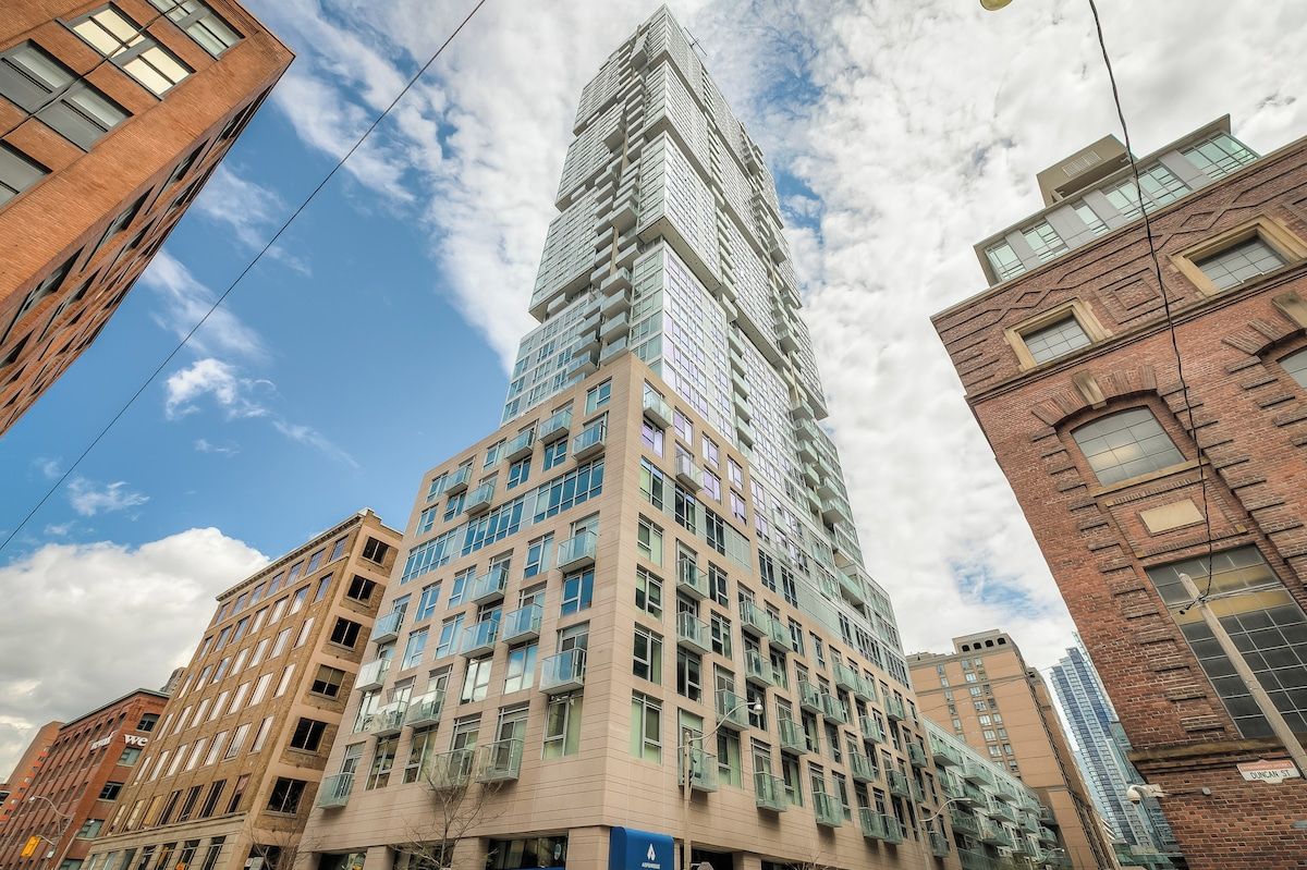 A high-rise building with multiple floors, large windows, and a mix of architectural styles.