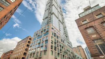 A high-rise building with multiple floors, large windows, and a mix of architectural styles.