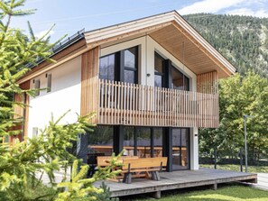 A modern two-story house with a balcony, large windows, and a wooden deck. - Chalet With 4 Bedrooms, Sauna & Fireplace (Biberwier)