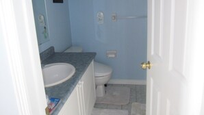 A bathroom with a white sink, toilet, and shower area. - Cosy Room with exclusive bathroom (Mississauga)