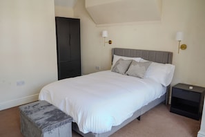 A bedroom with a bed, bedside tables, a bench, and a wardrobe. - Modern Apartment | 5 min Walk to Watford Junction (Watford)