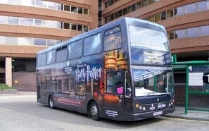 A double-decker bus with a Harry Potter themed advertisement. - Modern Apartment | 5 min Walk to Watford Junction (Watford)