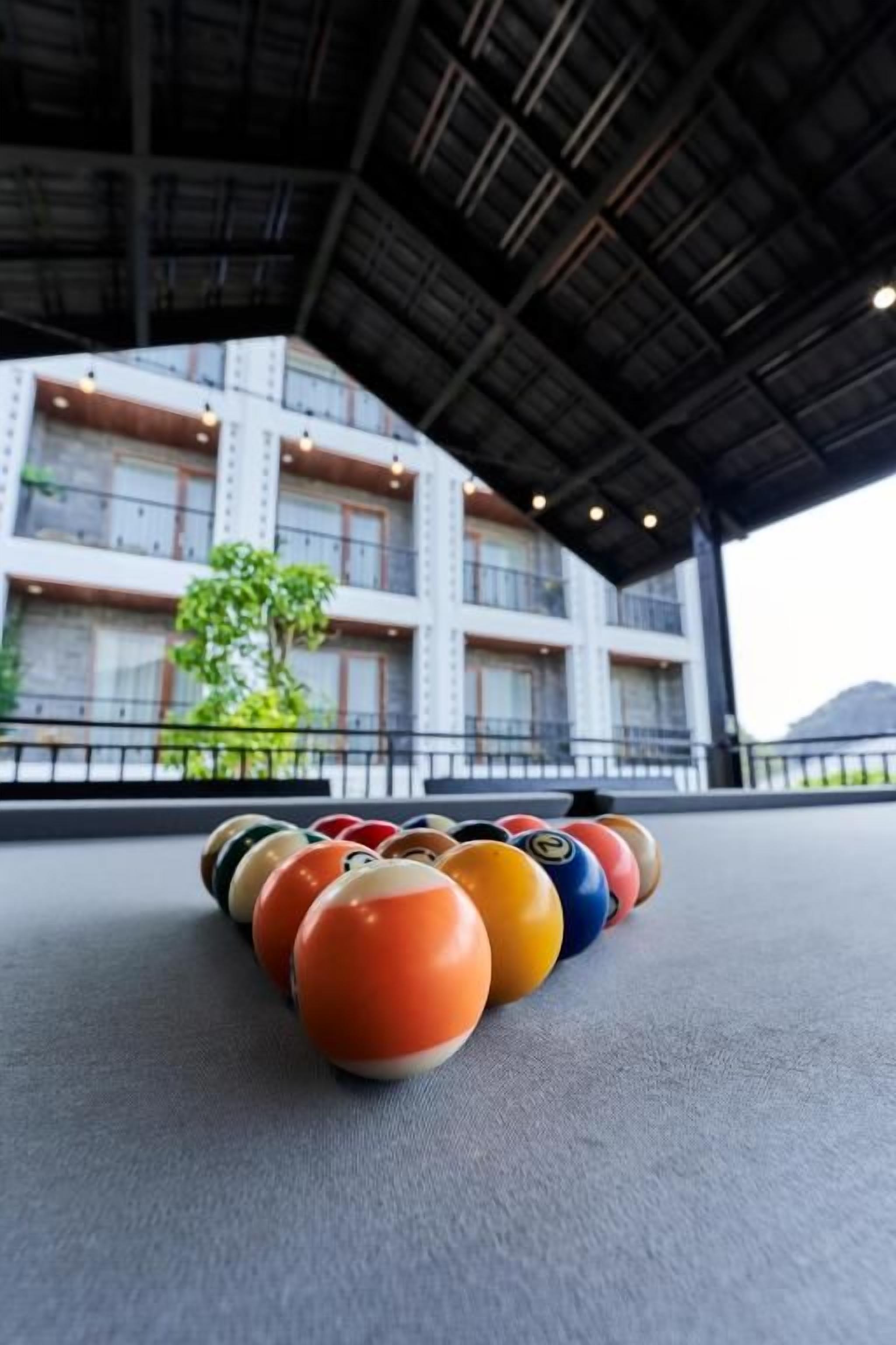 A pool table with billiard balls arranged in a triangle formation.
