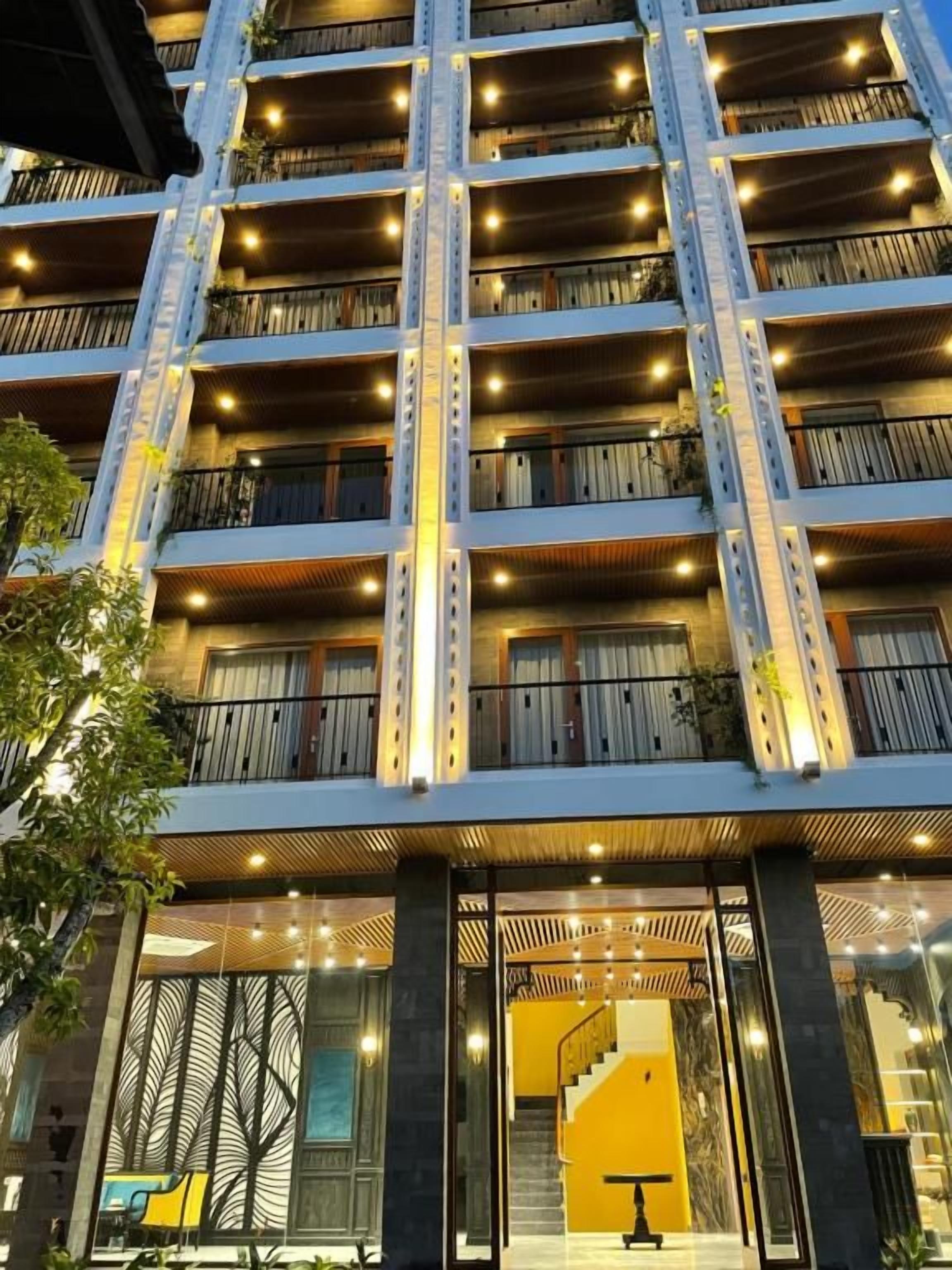 A multi-story hotel with balconies, a staircase, and a modern design.