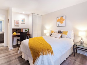 A hotel room with a bed, bedside lamps, a desk, and a chair. - Modern Poolside Condo, 2 BR + Flex Space with Bed (Palm Desert)