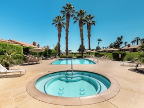A pool area with lounge chairs and palm trees. - Modern Poolside Condo, 2 BR + Flex Space with Bed (Palm Desert)