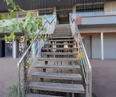 A staircase with metal railings leading to a building entrance.