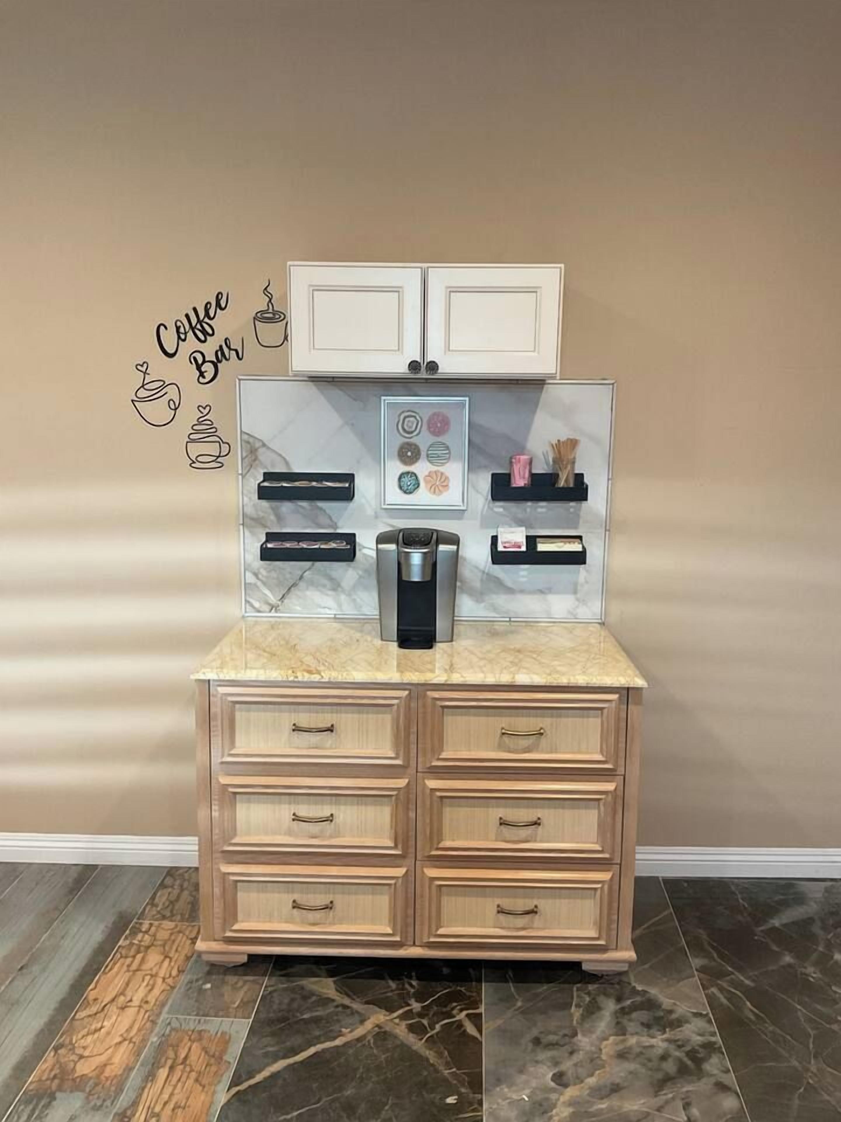 A kitchenette with a coffee machine, a microwave, and a small refrigerator.