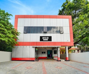 A two-story building with a sign reading 'HOTELO' and a company-serviced logo. - Classic Hotel Jaisas Paradise (Nagercoil)
