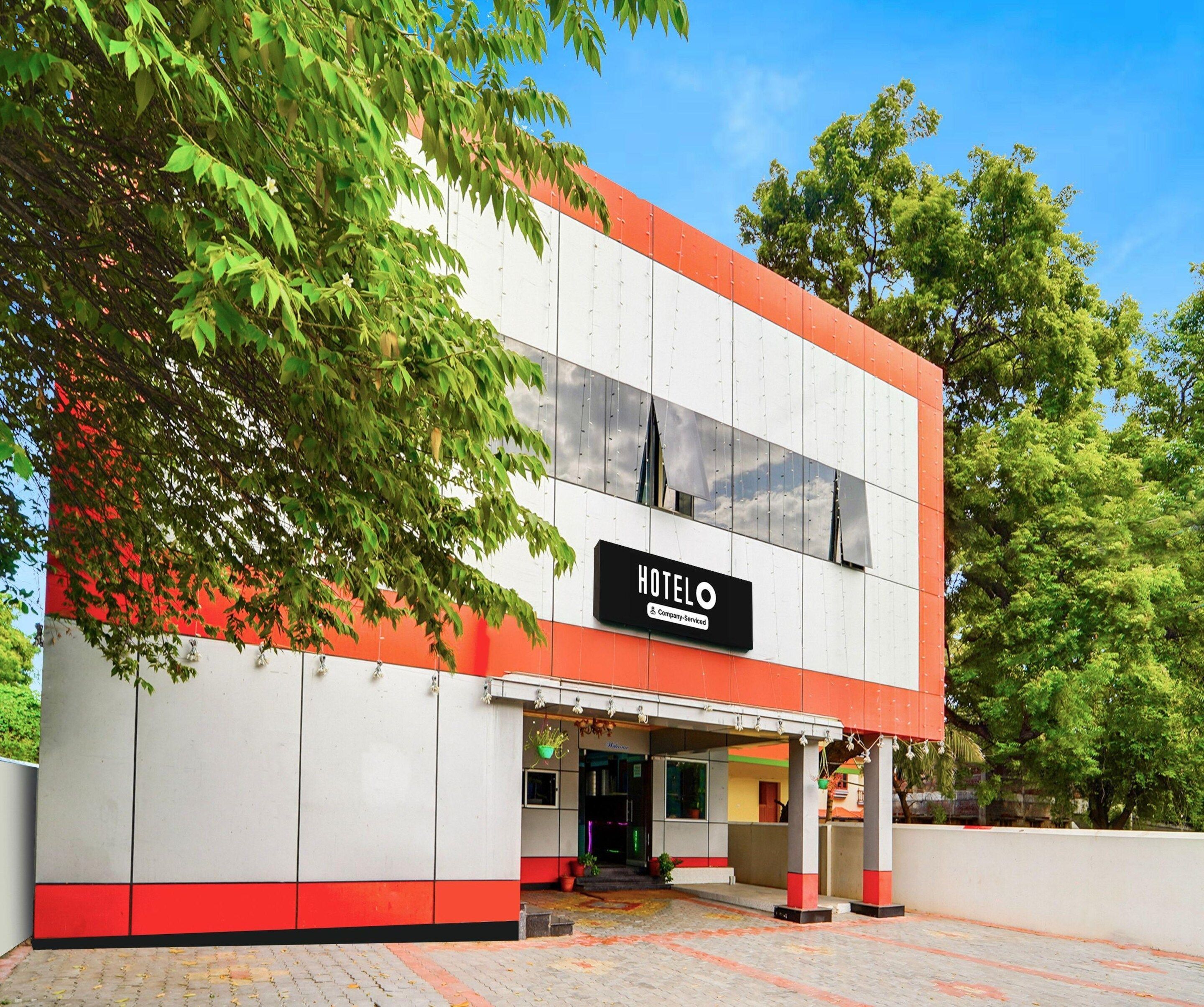 A two-story building with a sign reading 'HOTEL' and a company-serviced logo.