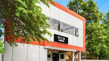 A two-story building with a sign reading 'HOTEL' and a company-serviced logo.