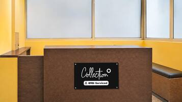 A reception desk with a sign that reads 'Collection' and 'OYO-Serviced.'