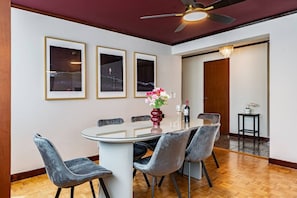 A dining area with a round table, six chairs, and framed artwork on the wall. - 3BR Near Reforma & Mexico City Historic Center (Mexico City)
