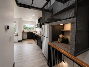 A modern kitchen with a built-in seating area, a view to the outdoors, and a dining area with a view. - Altura Tower - With a View (Lancaster)