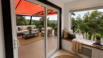 A modern interior with a sliding glass door leading to an outdoor patio area.