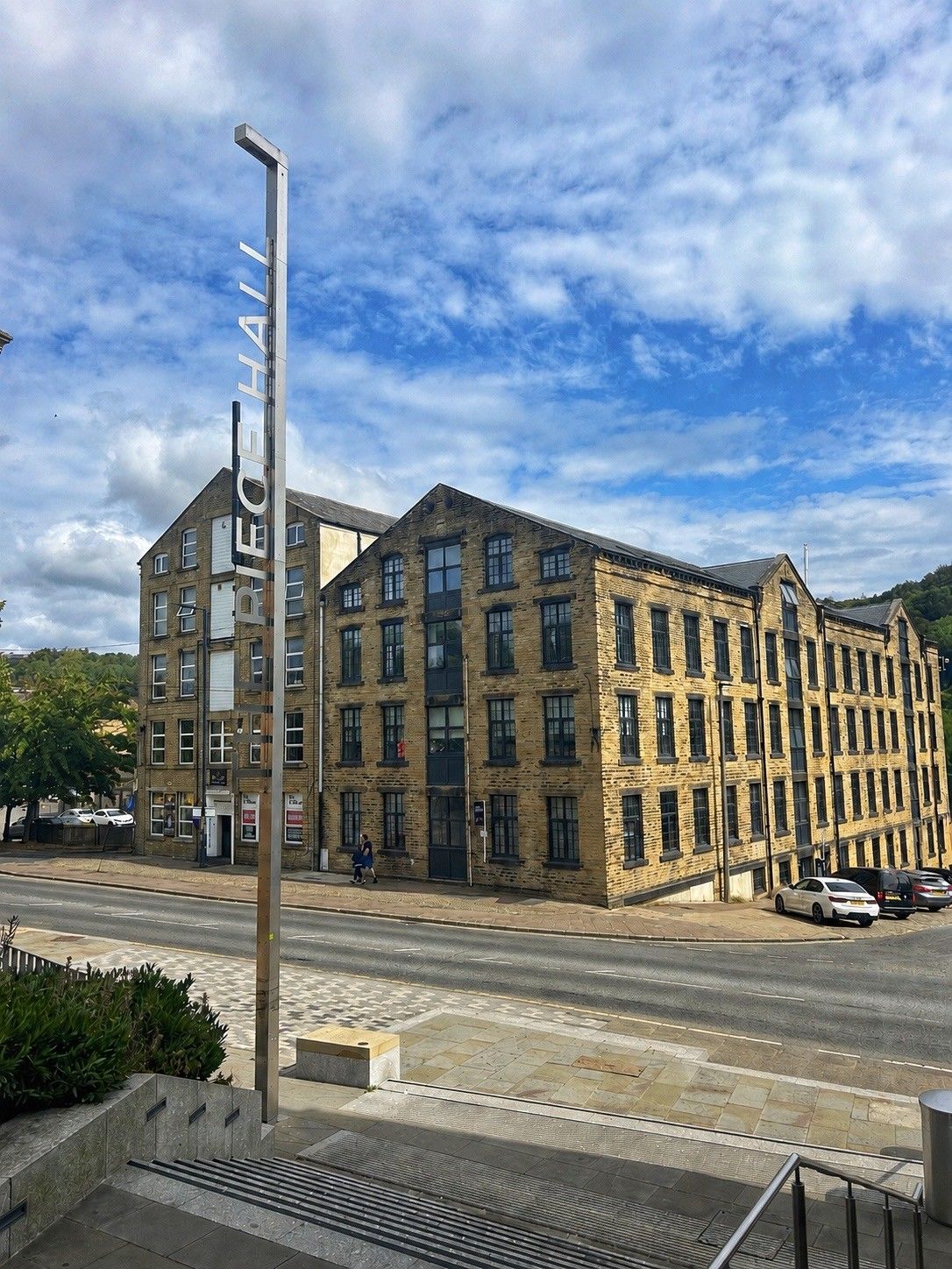 A multi-story building with a prominent sign on the corner.