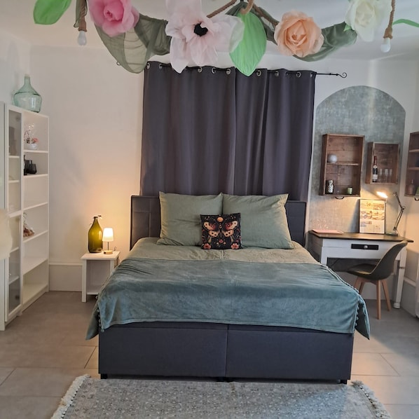 Une chambre à coucher avec un lit, un bureau et une étagère.