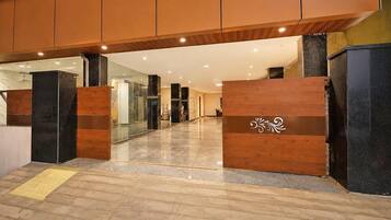 A modern interior with a polished floor, wooden paneling, and glass partitions.