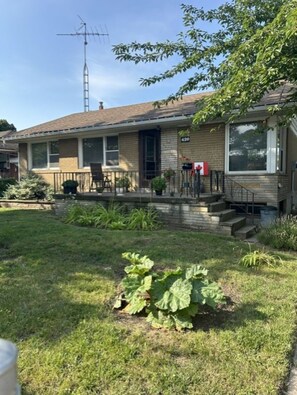 A residential house with a front yard, a mailbox, and a satellite dish. - Central Oakville/Kerr Village:steps to shops, eateries, cinema, transit, & GO  (Oakville)