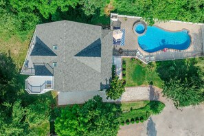 A residential property with a swimming pool, a covered patio, and a large house with a sloped roof. - Cape Mayzing! Pool, Sleeps 12, West Cape May (West Cape May)