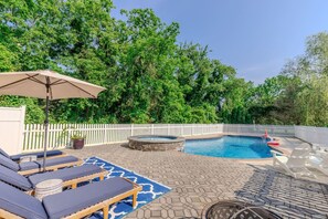 An outdoor swimming pool with lounge chairs and a hot tub, surrounded by a white fence and lush greenery. - Cape Mayzing! Pool, Sleeps 12, West Cape May (West Cape May)