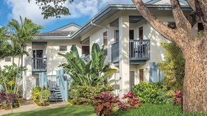 A row of two-story townhouses with balconies, surrounded by lush greenery and a well-maintained lawn. - Kauai Presidential Villa with Pools, Views & Spacious 2BR Princeville Escape (Princeville)