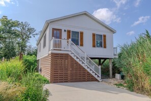 A two-story house with a wooden deck and a staircase leading to the upper floor. - •Bay Views• Close to Cape May & Wildwoods • (Middle Township)