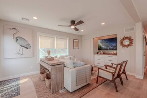 A bedroom with a bed, a desk, a chair, a ceiling fan, a window, and a painting. - •Bay Views• Close to Cape May & Wildwoods • (Middle Township)