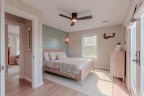 A bedroom with a bed, a ceiling fan, a window, and a door. - •Bay Views• Close to Cape May & Wildwoods • (Middle Township)