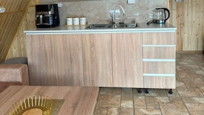 A compact kitchen with wooden cabinets, a countertop, and a sink. - Getamej Eco Villa & Pool (Getamej)