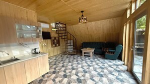 A wooden interior with a kitchen, dining area, and a staircase. - Getamej Eco Villa & Pool (Getamej)