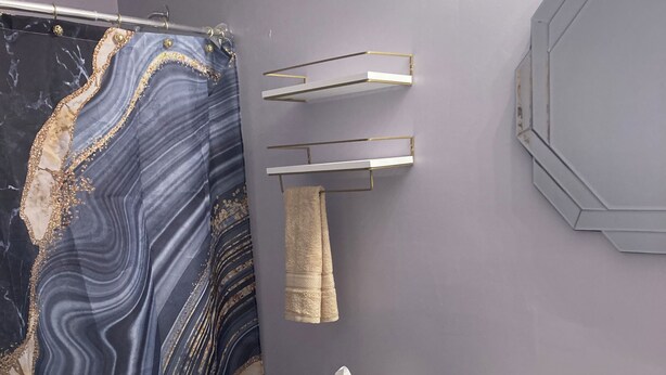 A bathroom with a toilet, sink, and a towel rack. - Charming 2-bedroom house in superb Wyandotte with AC (Wyandotte)
