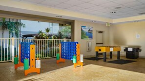 A fitness area with exercise equipment, a foosball table, and a view of the outdoors. - 2 Bedroom Twin at WorldMark Kihei (Kihei)