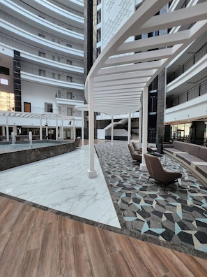 A multi-level indoor space with a central open area, seating arrangements, and a patterned floor. - Sirius Town Residence spa Luxury With Terrace (Antalya)