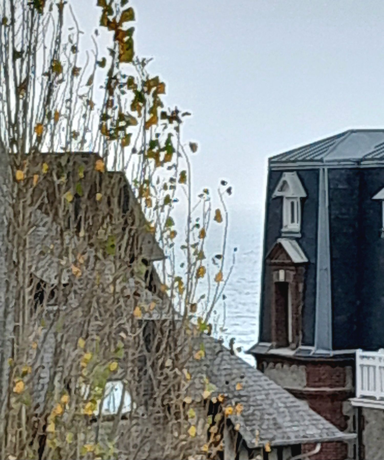 A building with a dark facade, a small window, and a chimney.