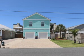 A two-story house with a front garage, a paved driveway, and a well-maintained lawn. - Aloha PCB: Walk to the Beach - Modern, Impeccable & Fully Stocked (Panama City)