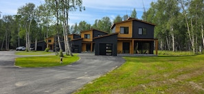 A modern two-story house with a covered porch and a driveway.