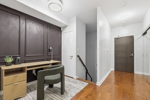 A modern home office with a desk, chair, and a potted plant. - 3BR/3BA Downtown Toronto + Free Parking | Parking Available (Toronto)