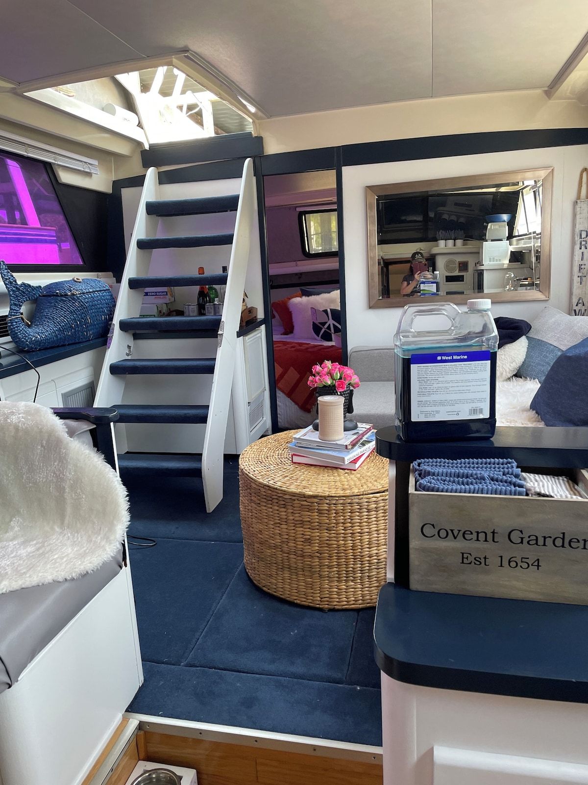 A compact living space with a bunk bed, a kitchenette, and a small dining area.