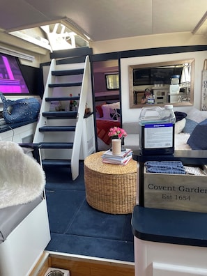 A compact living space with a bunk bed, a kitchenette, and a small dining area.