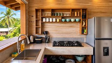 A modern kitchen with wooden cabinetry, a stainless steel sink, and a built-in gas stove.