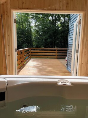 A wooden deck with a railing, leading to a wooden door. - Secluded Catskills Retreat w/ Hot Tub & Views (Jewett)