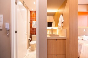 Ein modernes Badezimmer mit Toilette, Waschbecken und Handtuchhalter.