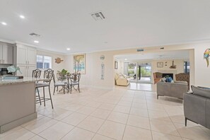 A spacious living area with a kitchen, dining area, and seating space. - Waterfront Fort Myers Beach Retreat (Fort Myers Beach)